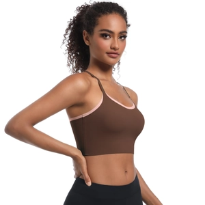 Detail of cross strap back sports bra with brown and pink contrast trim
