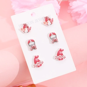 Detailed set of gnome earrings featuring American football themes on a display card