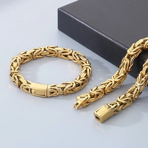 Detailed macro view of golden Byzantine chain necklace and bracelet set in punk style