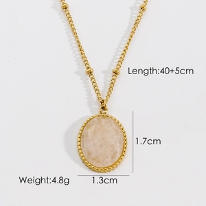 Detail of gold necklace with oval pink stone pendant and decorative bead border