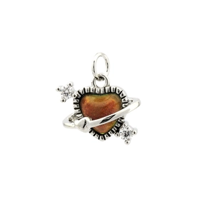 Macro detail of heart planet pendant with amber crystal and cubic zirconia stones