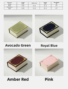 Macro shot of book-shaped jewelry boxes in four vintage colors with golden floral frames