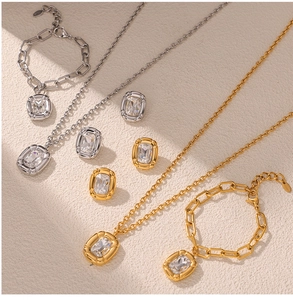 Detail of elegant gold and silver titanium jewelry set with rectangular gemstones