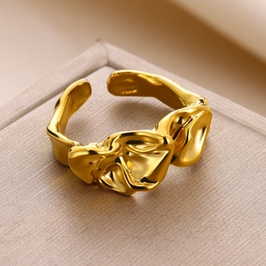 Detailed close-up of gold irregular heart ring with liquid lava metal texture