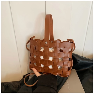Detail of vintage brown woven crossbody bag featuring a white drawstring inner pouch