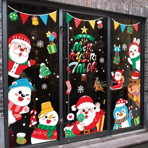 Festive Christmas window stickers featuring Santa Claus and snowman on glass shop door