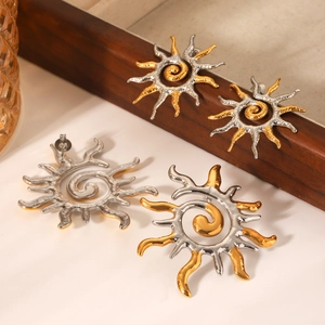 Two-tone sun flame stainless steel stud earrings with spiral texture on wooden tray