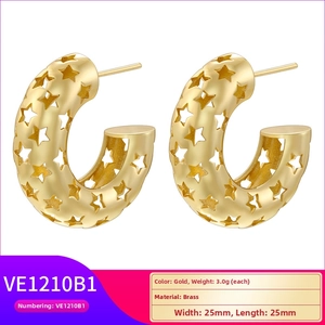 Detailed brass C-shaped gold hoop earrings with intricate hollow star patterns