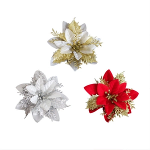 Glittering artificial poinsettia flowers in gold, silver, and red for Christmas tree decor
