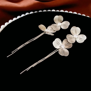 Detail of silver vintage flower earrings with long tassels and sparkling zircon centers