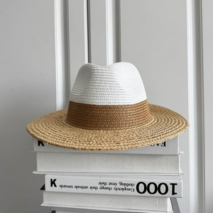 Detailed macro view of the two-tone raffia weave texture on a stylish straw jazz hat