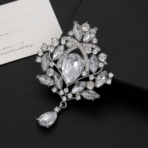 Macro shot of silver crystal flower brooch with marquise diamonds on a black jewelry box