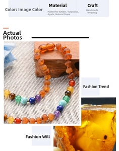 Detail of handmade amber and turquoise beads necklace on a rustic wooden base
