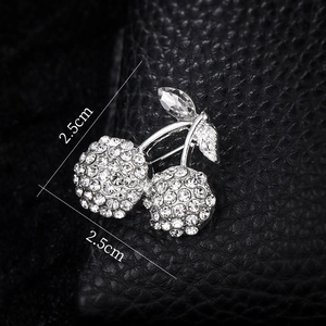 Macro view of crystal cherry brooch with rhinestones measuring 2.5cm by 2.5cm