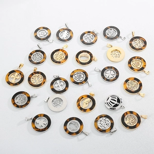 Flat lay of multiple tortoiseshell and metal hollow pendant necklaces with various motifs