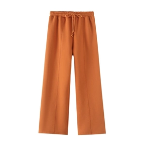 Vibrant orange drawstring sweatpants with center seam detail and elastic waistband