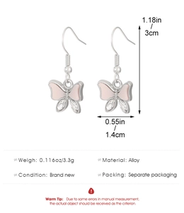 Detail view of pink butterfly earrings with white pear-shaped cubic zirconia and alloy hooks