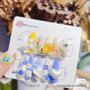 Detail of 5D embossed nail stickers featuring floral, butterfly, and pearl resin art