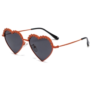 Orange heart-shaped polarized kids sunglasses with 3D floral accents on metal frame