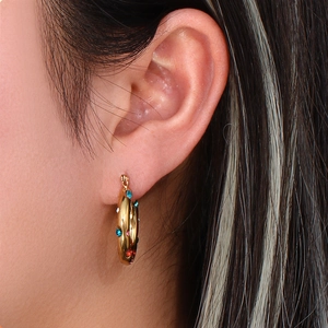 Detail of 18K gold plated hoop earrings with colorful zircon stones on model