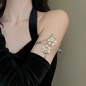 Silver flower arm cuff with white crystals and twisted metal texture on female arm