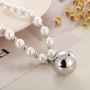 French style elastic pearl necklace with silver beads and a hollow steel sphere pendant