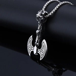 Macro detail of silver stainless steel viking battle axe pendant with skull design