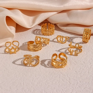 Close-up of a 9-piece gold ring set featuring star, LOVE, and mesh hollow out designs