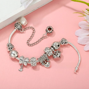 Detail of silver-plated snake chain bracelet with heart charms and butterfly pendant