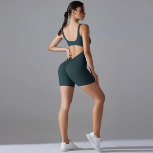 Close-up of dark green open back yoga bodysuit with scrunch butt lifting detail