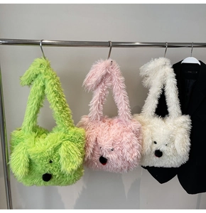 Detail of three fluffy puppy-shaped plush tote bags in green, pink, and off-white colors