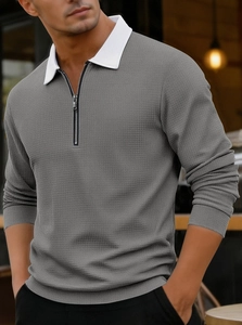 Detail of grey waffle knit long sleeve polo shirt with white contrast collar and metal zipper