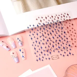 Star pattern nail stickers in blue and red shown on artificial nails with pearls