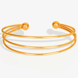 Detailed close-up of a triple-layered 18K gold plated stainless steel open cuff bracelet