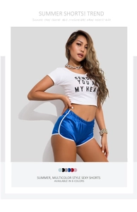 Detail of high-waisted blue satin athletic shorts showing shiny texture and slim fit design