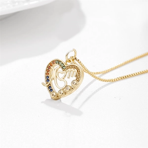 Detailed shot of gold heart MOM pendant with colorful gemstones and micro-paved zircons