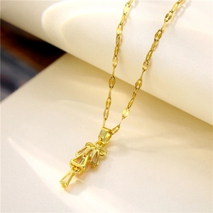 Elegant gold necklace with abstract figure pendant and unique wavy chain on neutral paper
