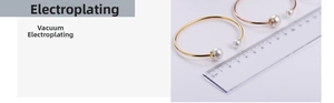 Detail of vacuum plated stainless steel cuff bracelet with large pearls in gold and rose gold