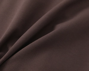 Macro shot of dark brown high-density plain weave fabric with elegant texture draping