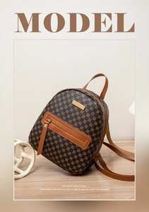Close-up of brown floral backpack with geometric patterns and golden metal hardware details