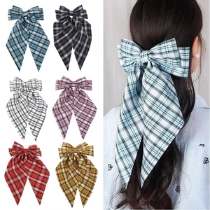 Plaid bow hair clips in six colors with a model wearing the blue ribbon style