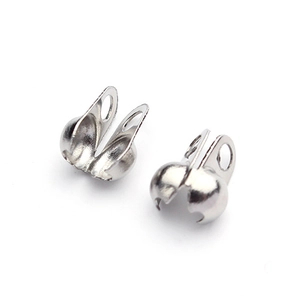 Close-up of silver metal bead chain connectors and fold-over crimp ends for jewelry