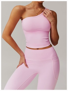 Close-up of pink one-shoulder yoga tank top and leggings with practical side pockets