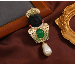 Detail shot of vintage exotic brooch featuring colorful gemstones and pearl fringe detail