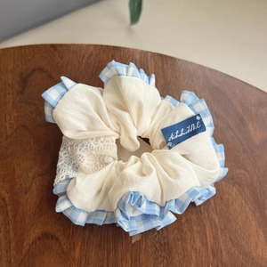 Beige oversized hair scrunchie with blue checkered ruffle trim and delicate lace detail