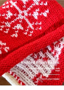Close-up of red and white knitted plush fabric with classic Nordic snowflake patterns