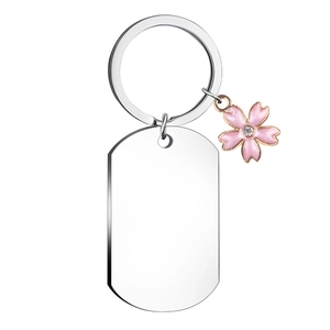 Silver stainless steel dog tag keychain with delicate pink cherry blossom charm