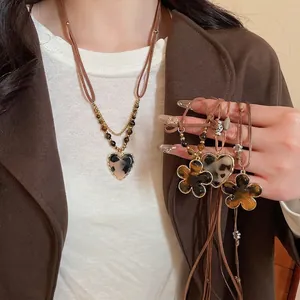 Ethnic style heart and flower pendant necklace with leopard print resin and gold metal edge