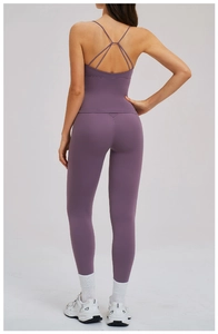 Back view of purple yoga set featuring cross-strap sports bra and high-waist leggings