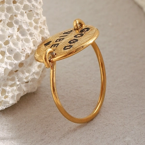 Detailed macro view of 18K gold plated ring with Good Vibes oval engraved pendant